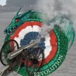 front cover of book with French Revolution rosette and a smoking cannon inside green snake. Entitled The Power of the Wouivre